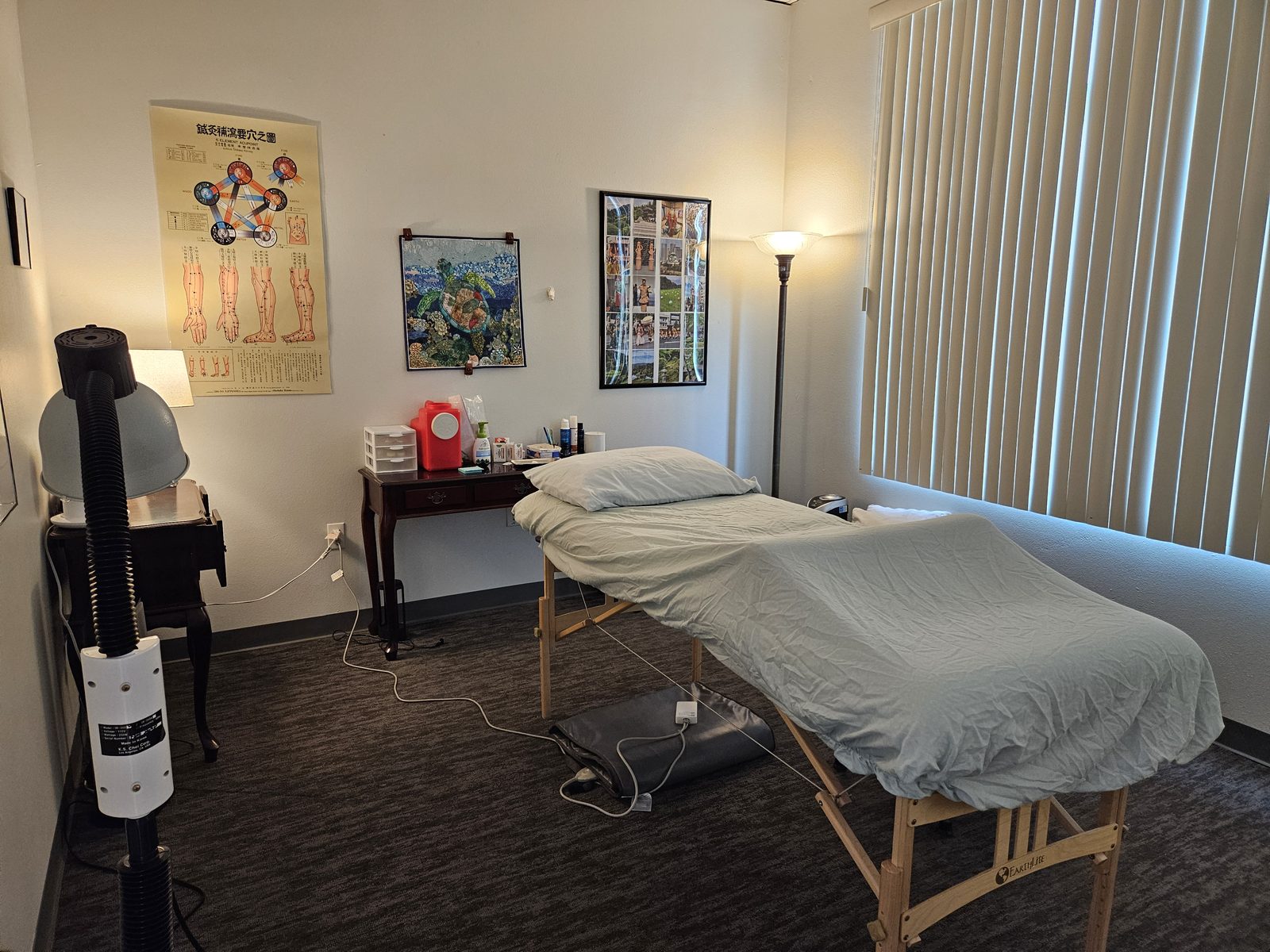 Treatment room at Spring Mountains Acupuncture in Las Vegas, with the treatment table and a TDP heat lamp.